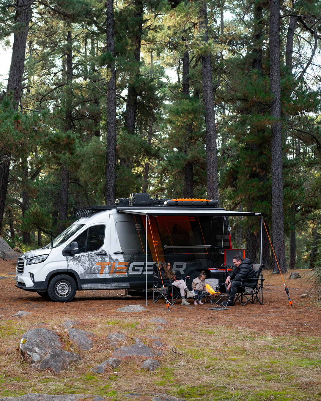 Sitting around the fire in the forrest camping with the family | Van camping | Camping Accessories | Tiegear Guy Rope | Screw in Pegs