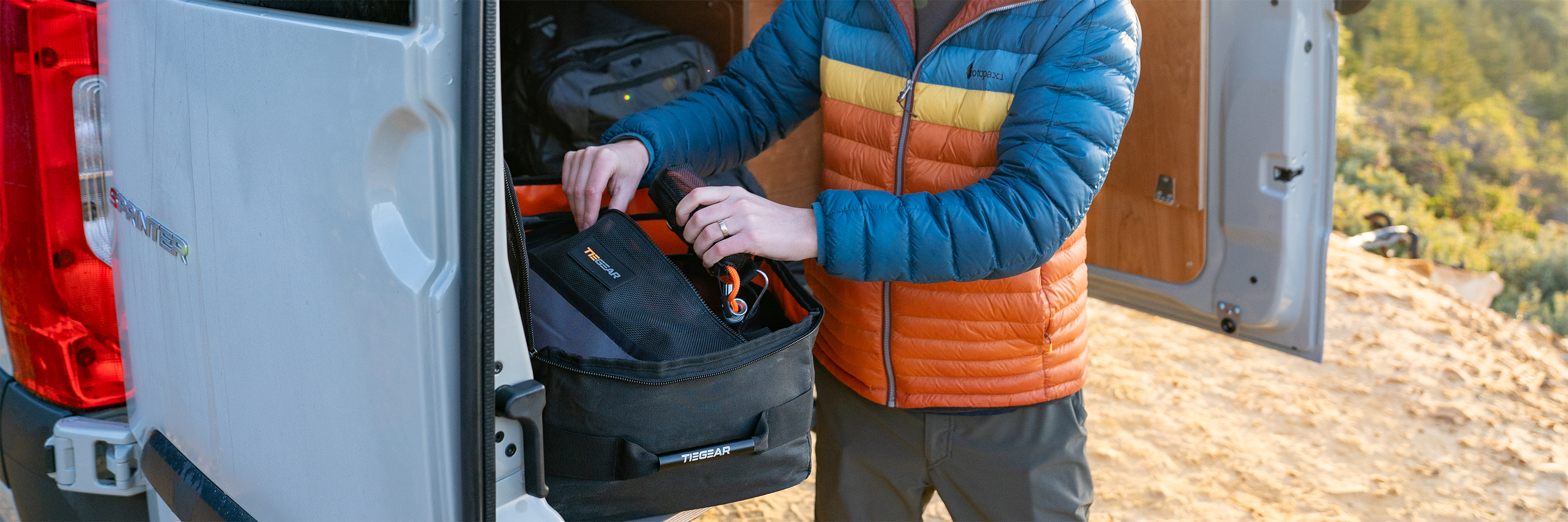 Guy pulling out tie down gear from storage bag | Camping Storage Solutions | Tiegear Accessories