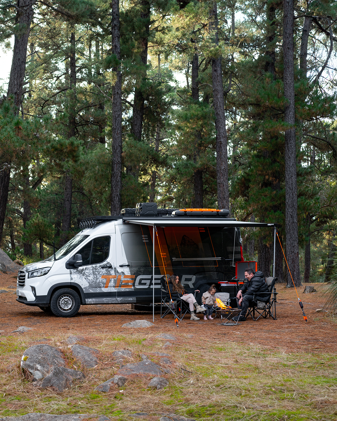 Sitting around the fire in the forrest camping with the family | Van camping | Camping Accessories | Tiegear Guy Rope | Screw in Pegs 
