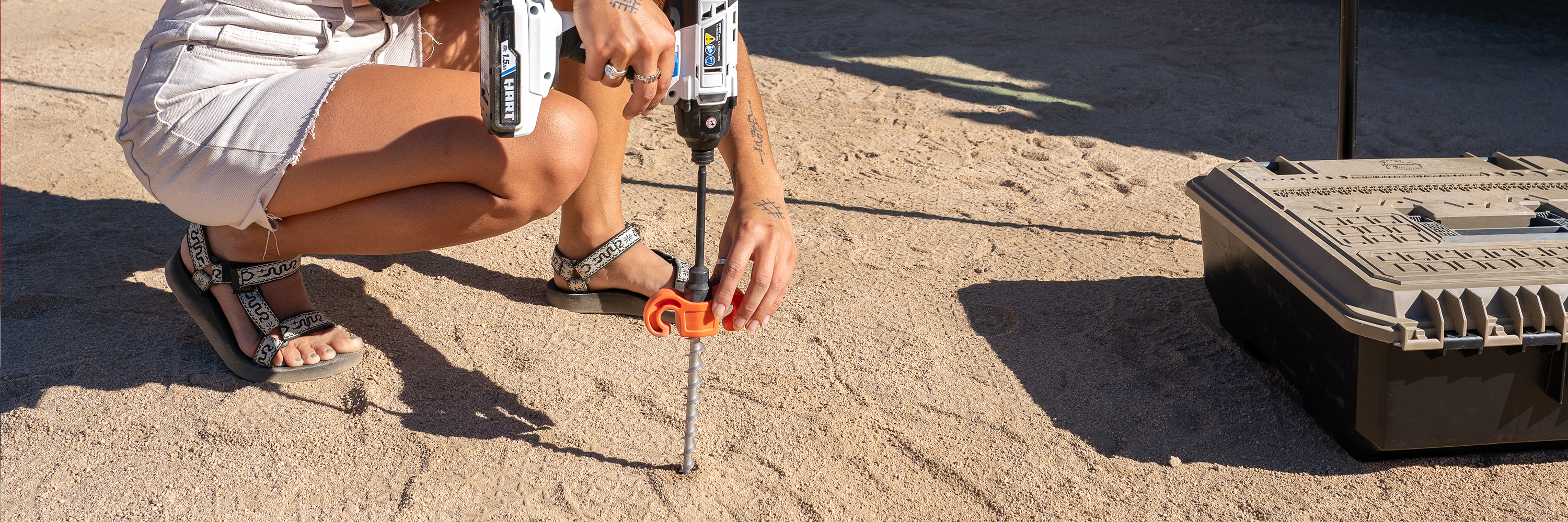 Female drilling peg into hard ground | Tiegear Terra Pegs | Screw in Pegs | Heavy Duty Pegs | Heavy Duty Stake | Camping Stake | Screw in Stake